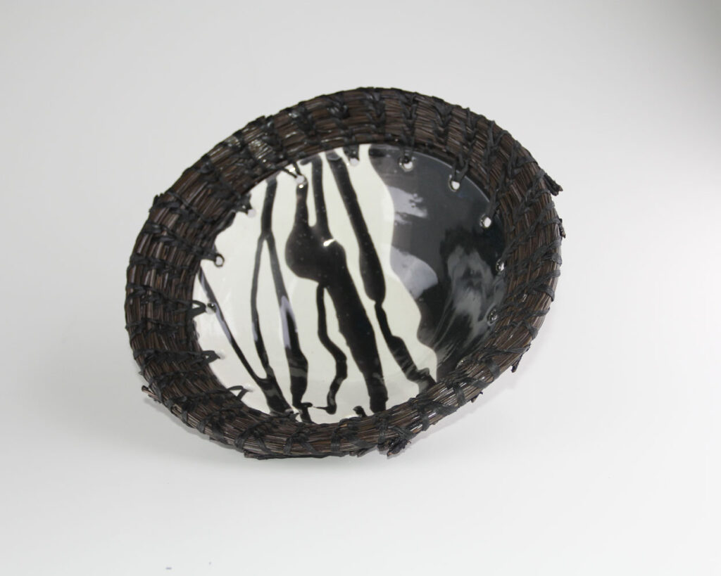 A round black and white plate with a zebra print.