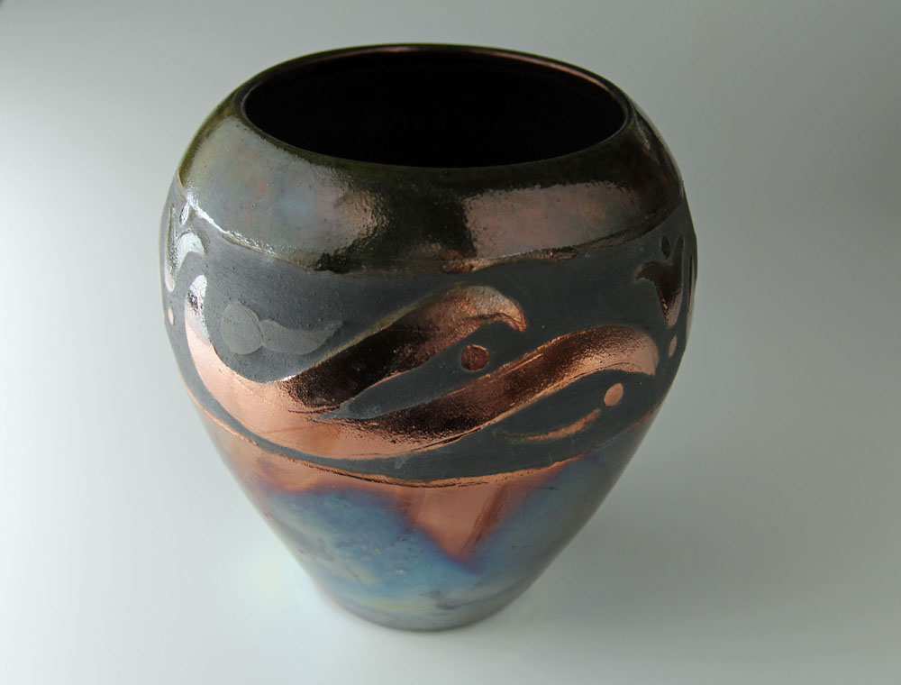 A vase with some brown and blue designs on it