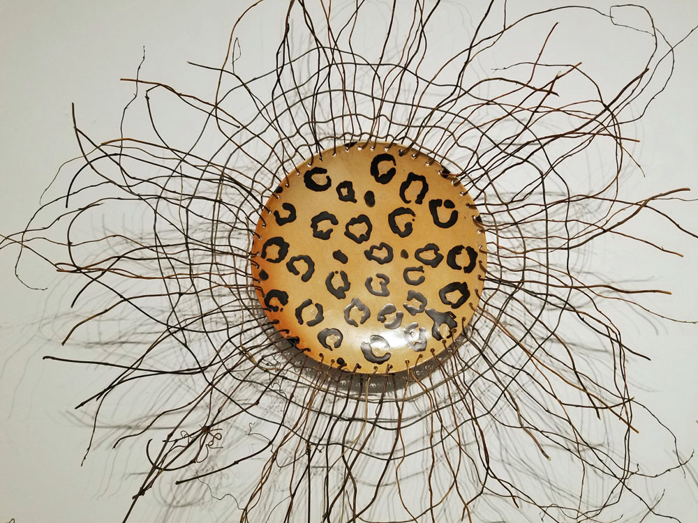A leopard print plate with some brown branches