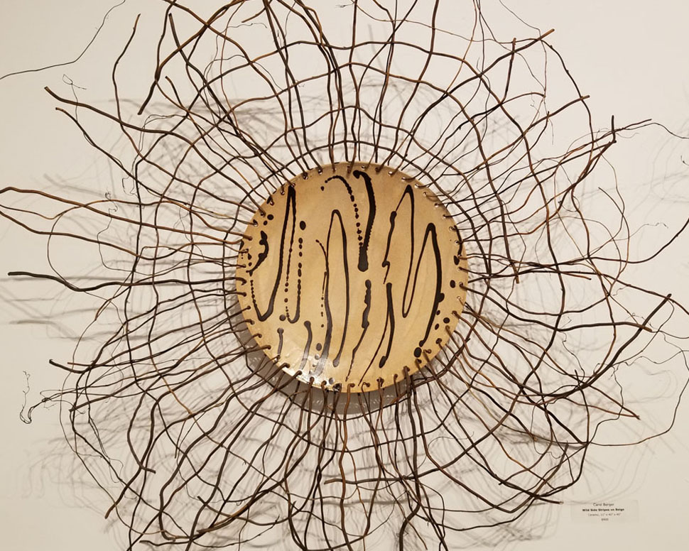 A circular sculpture of branches and a plate.