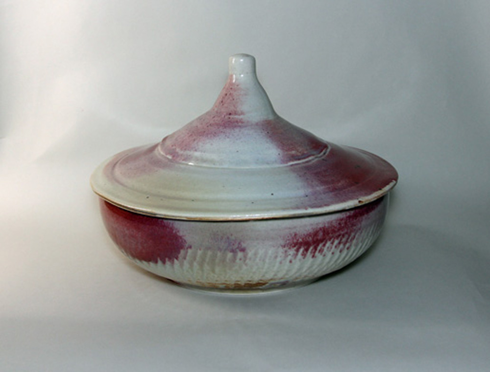 A bowl with a lid is shown on the table.