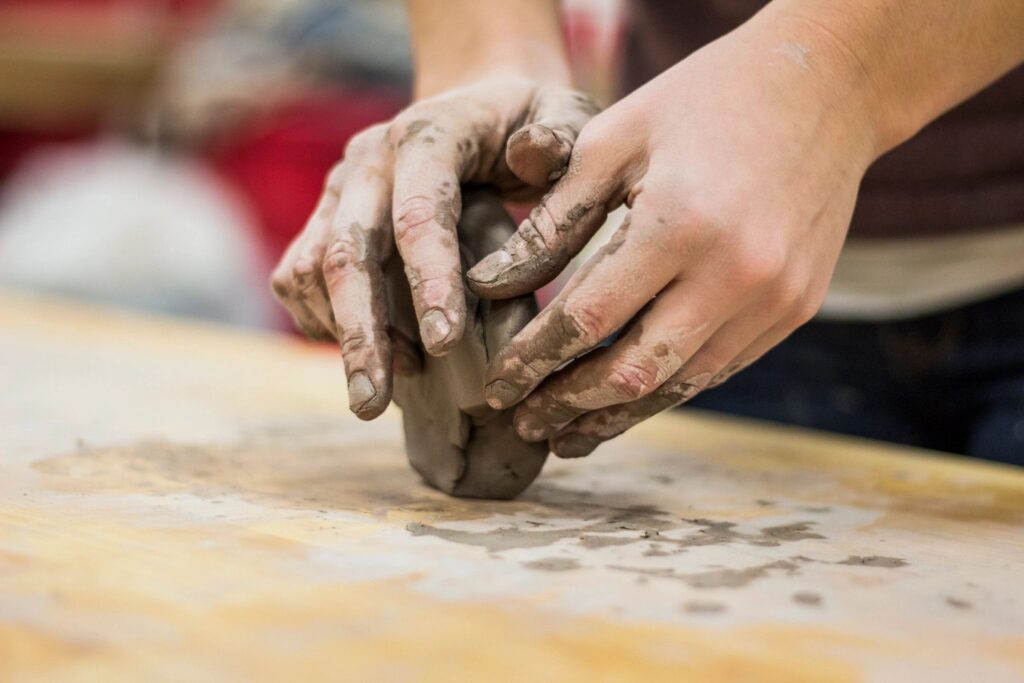 A person is making clay on the table