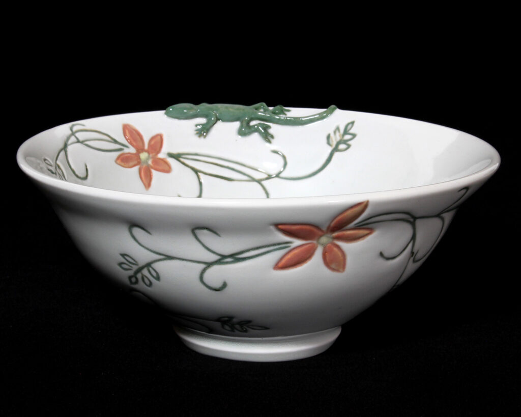 A bowl with flowers and leaves on it.